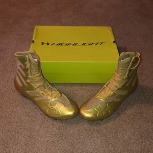 Gold high top Under Armour cleats